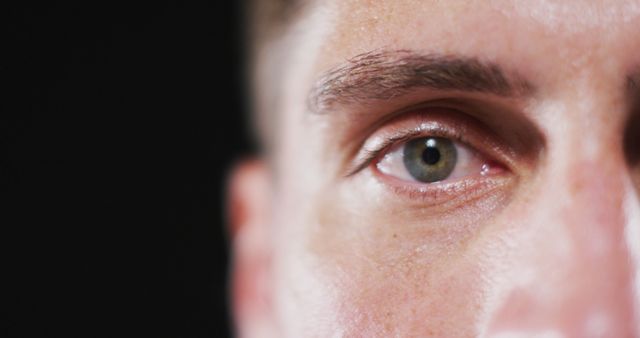 Close up portrait of face of caucasian man with focus on blinking eye. human vision and sight, eye detail.