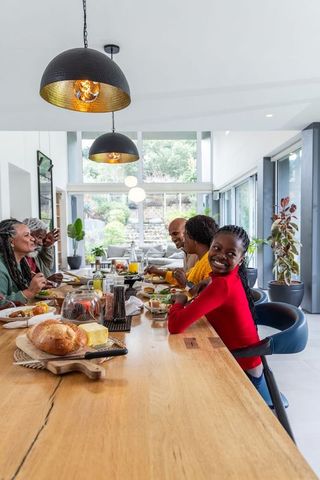 African american family sharing weekend brunch at modern dining table with bright decor