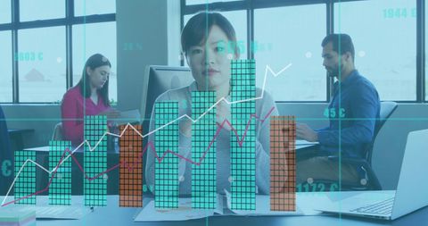 Asian Businesswoman Analyzes Financial Graphs in Modern Office