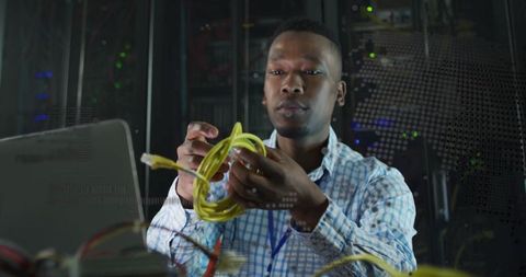 Network technician untangling ethernet cable in data center