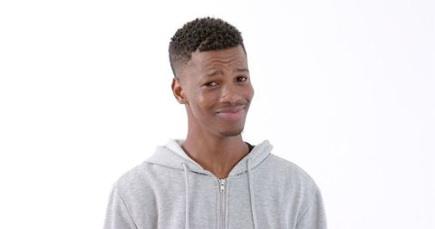 Young Man in Gray Hoodie Fairly Expressing Skepticism