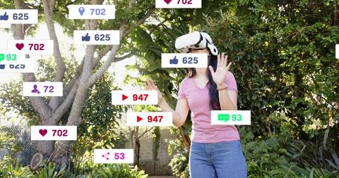 Young woman wearing vr headset interacting with floating social media metrics in garden