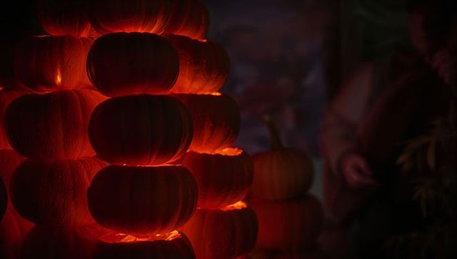 Glowing pumpkin tower at nighttime fall festival celebration