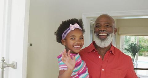 Smiling Grandfather with Granddaughter Together at Home - Download Free Stock Images Pikwizard.com