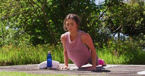 Woman Practicing Yoga in Forest Setting