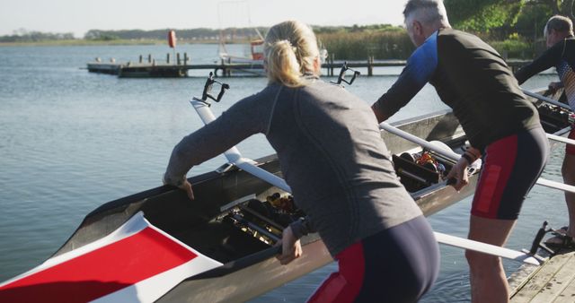 Rowers Preparing Boats by Lakeside Dock for Morning Exercise - Download Free Stock Images Pikwizard.com