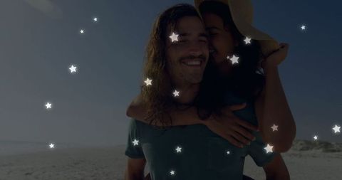 Couple Piggybacking on Beach Beneath Starry Overlay Reflection