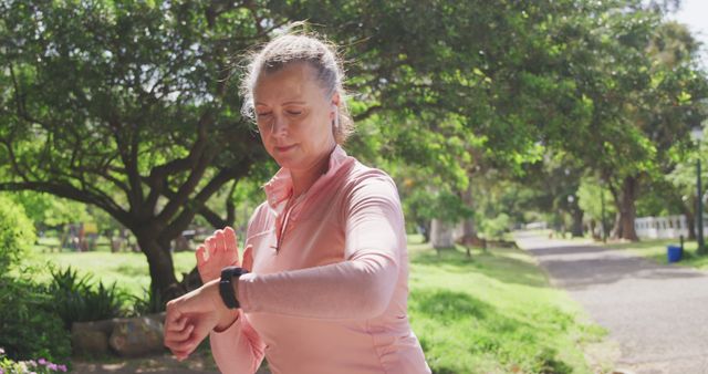 Senior Woman Checking Fitness Tracker During Outdoor Exercise - Download Free Stock Images Pikwizard.com