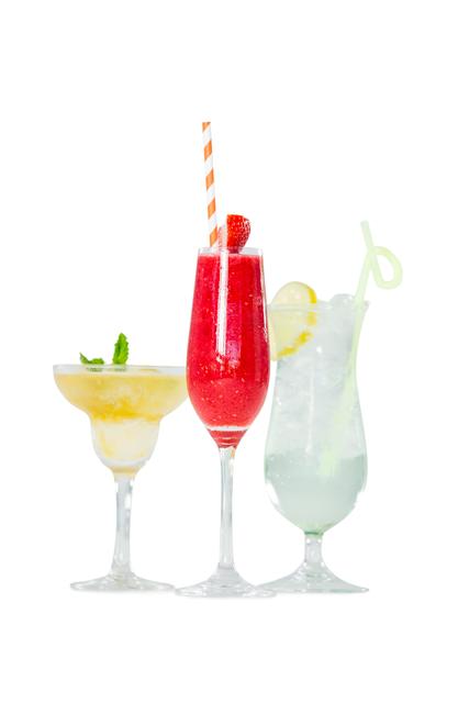 Three different cocktails presented in elegant glasses, each with unique garnishes. Perfect for use in advertisements for bars, restaurants, or events. Ideal for summer party promotions, drink menus, or social media posts celebrating festive occasions.