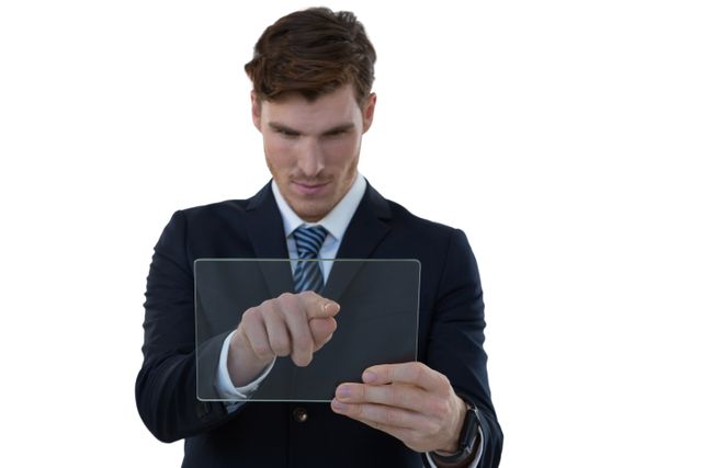 Businessman using transparent glass tablet, ideal for illustrating concepts of modern technology, innovation, and digital interaction in corporate settings. Perfect for business presentations, tech-related articles, and futuristic design projects.