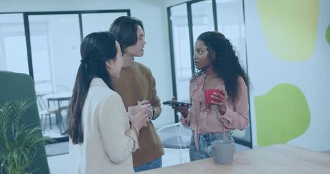 Young Professionals Socializing in Modern Office Break Area