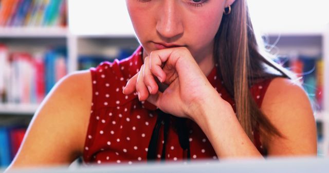 Young Female Student Deep in Thought Studying in Library - Download Free Stock Images Pikwizard.com