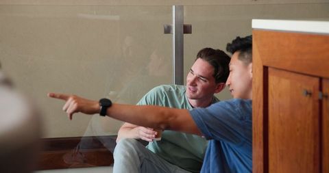 Diverse Male Couple Relaxing at Home Sharing Laughter