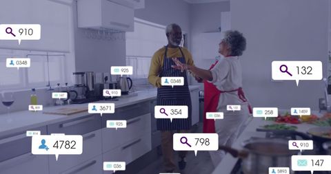 Senior Couple Enjoying Dance in Kitchen with Social Media Notifications