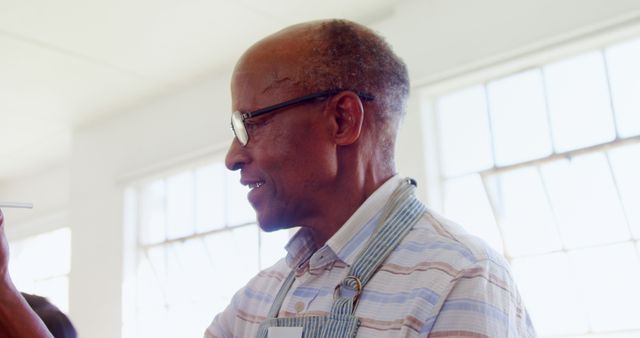 Elderly Man Wearing Apron Smiling Indoors - Download Free Stock Images Pikwizard.com