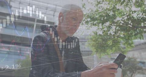 Senior man checking smartphone while holding coffee with stock market overlay