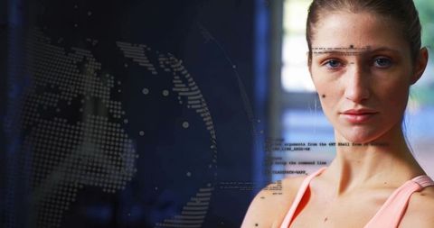 Confident woman standing in studio facing camera with digital globe and code overlay