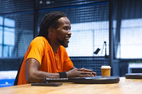 Athletic Individual Engaging in Discussion at Modern Workspace