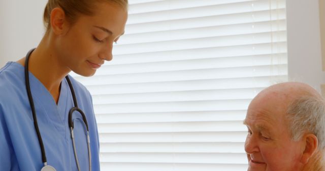 Caring Nurse Attending to Elderly Patient in Medical Office - Download Free Stock Images Pikwizard.com