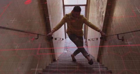 Urban exploration: man descending stairs in industrial setting