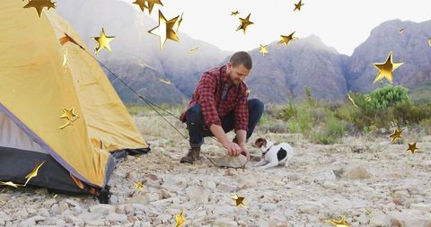 Camper and dog enjoy outdoor adventure on rugged campsite