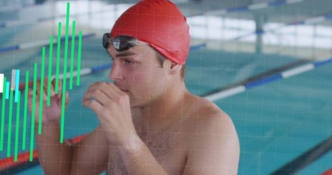 Competitive swimmer adjusting goggles at pool edge with performance data overlay
