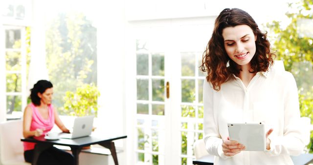 Woman Standing Using Tablet in Bright Office - Download Free Stock Images Pikwizard.com