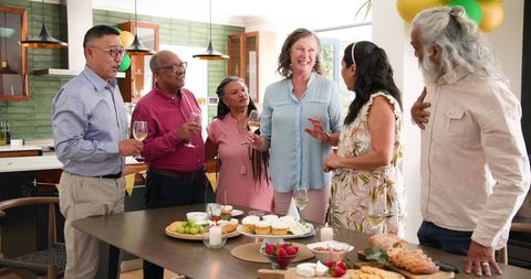 Diverse Senior Friends Enjoying Birthday Party Toast Together