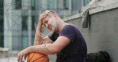 Tired basketball player sitting on rooftop holding ball and pressing forehead with hud overlay