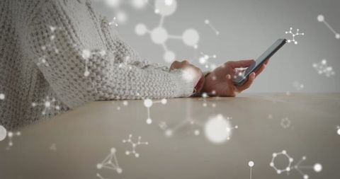 Woman in Sweater Using Smartphone with Molecular Network Overlay