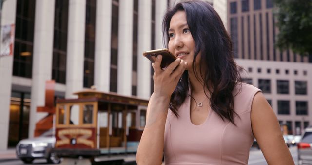 Businesswoman using smartphone voice command in urban setting - Download Free Stock Images Pikwizard.com