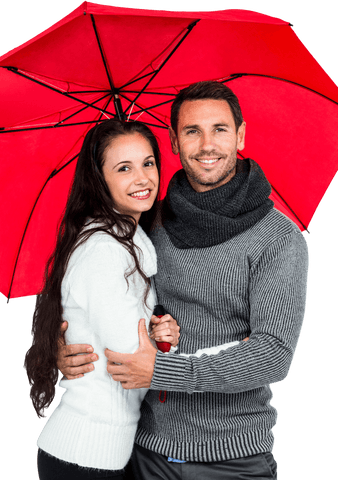 Couple embracing under transparent red umbrella, smiling in cozy sweaters
