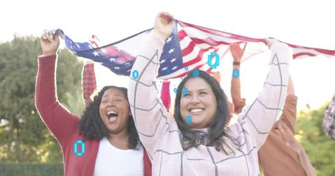 Diverse friends waving American flag, celebrating unity outdoors, smiling under sunlit sky