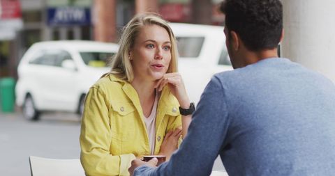 Caucasian Couple Conversing Happy at Outdoor Coffee Spot During Sunny Day