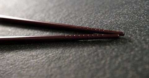 Close-Up of Wooden Chopsticks on Textured Surface