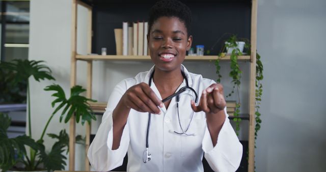 Smiling Female Doctor Holding Stethoscope in Modern Medical Office - Download Free Stock Images Pikwizard.com