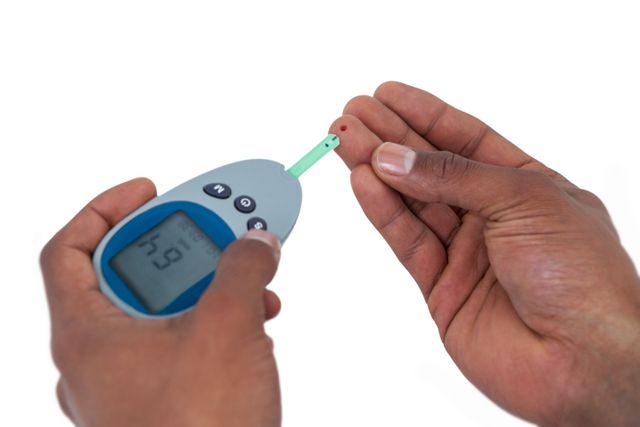 This image shows a close-up of hands using a glucometer to test blood sugar levels. It is ideal for use in healthcare articles, diabetes awareness campaigns, medical websites, and educational materials about diabetes management and self-care.