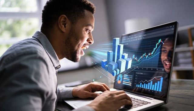 Business analyst studying financial charts with laptop holographic city data visualization