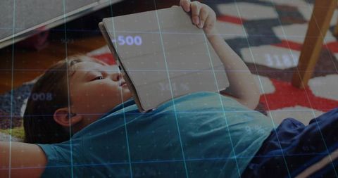 Child relaxing with tablet in comfortable home ambiance