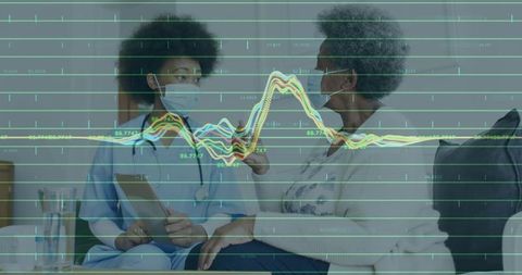 Nurse consulting with senior while reviewing vital signs and health analytics overlay