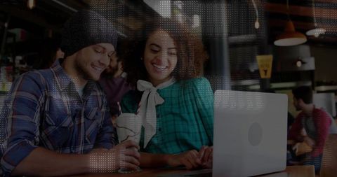 Smiling Friends Watching Laptop in Cozy Cafe
