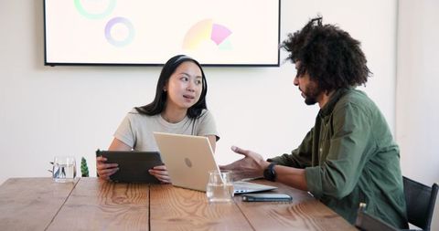 Collaborative Business Meeting with Laptop and Tablet