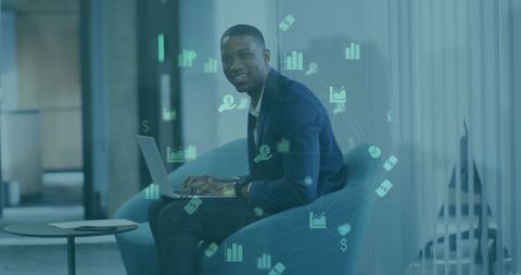 businessman analyzing data on laptop in modern office with economic icons - Download Free Stock Images Pikwizard.com