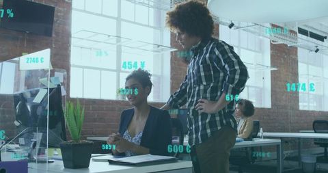 Reviewing augmented reality financial data, collaborating in modern loft workspace