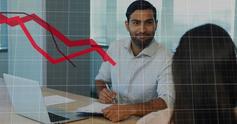 Business Professionals Analyzing Downtrend Data in Modern Office