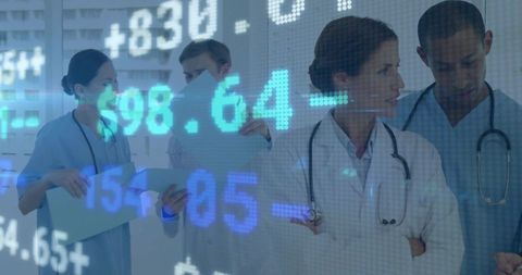 Medical Team Reviews Financial Data in Hospital Setting