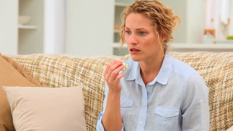Woman Relaxing on Couch with Popcorn