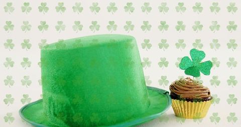 Celebrating st patrick's day with green felt top hat and shamrock-topped chocolate cupcake