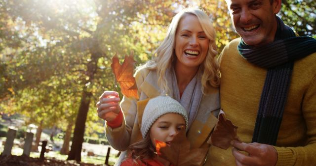 Happy Family Enjoying Fall Leaves in Park - Download Free Stock Images Pikwizard.com