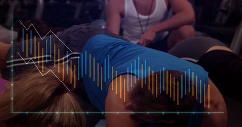 Man performing prone core exercise on mat with trainer and fitness analytics overlay, group